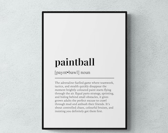 May include: A framed wall art print featuring a dictionary-style definition of the word paintball. The text is printed in black on a white background, including the phonetic pronunciation, the noun classification, and a descriptive paragraph.