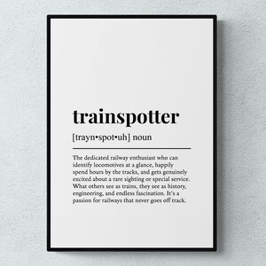 May include: A framed wall print featuring the word trainspotter in bold black text, followed by its phonetic pronunciation and a definition describing a dedicated railway enthusiast who identifies locomotives and appreciates engineering history.