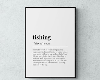 May include: A framed wall art print featuring a dictionary-style definition of the word fishing. The text is printed in black on a white background, including the phonetic pronunciation, part of speech, and a descriptive paragraph about the sport.