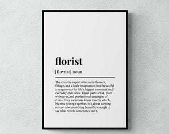 May include: A framed wall art print featuring a dictionary-style definition of the word florist. The text is printed in black on a white background, describing a florist as a creative expert who turns flowers and foliage into arrangements.