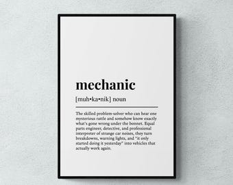 May include: A framed wall art print featuring a dictionary-style definition of the word mechanic. The text includes the phonetic pronunciation, the noun classification, and a descriptive paragraph about the role of a skilled problem-solver.