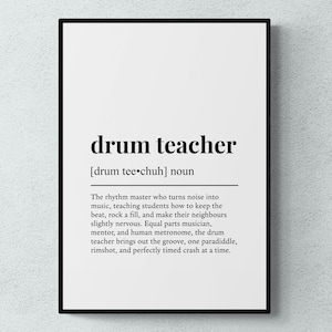 May include: A framed print featuring the words "drum teacher" in black, with a phonetic guide and a definition below. The definition describes the role of a drum teacher. The print is set against a white backdrop.