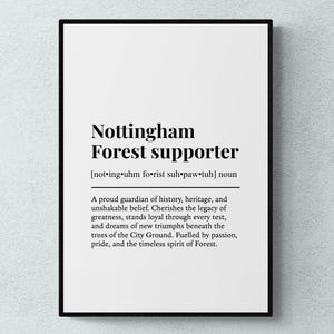 May include: A framed print with the words "Nottingham Forest supporter" in black text on a white background. The text includes a phonetic pronunciation and a definition describing the qualities of a supporter.