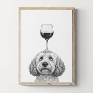 May include: A framed black and white print featuring a dog with a wine glass balanced on its head. The dog has curly fur and a sweet expression. The wine glass is filled with red wine.