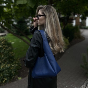 Blue leather hobo bag, spacious soft shoulder purse for women, made from high-quality genuine leather, minimalist modern design with comfortable handle, comes with matching leather wallet.