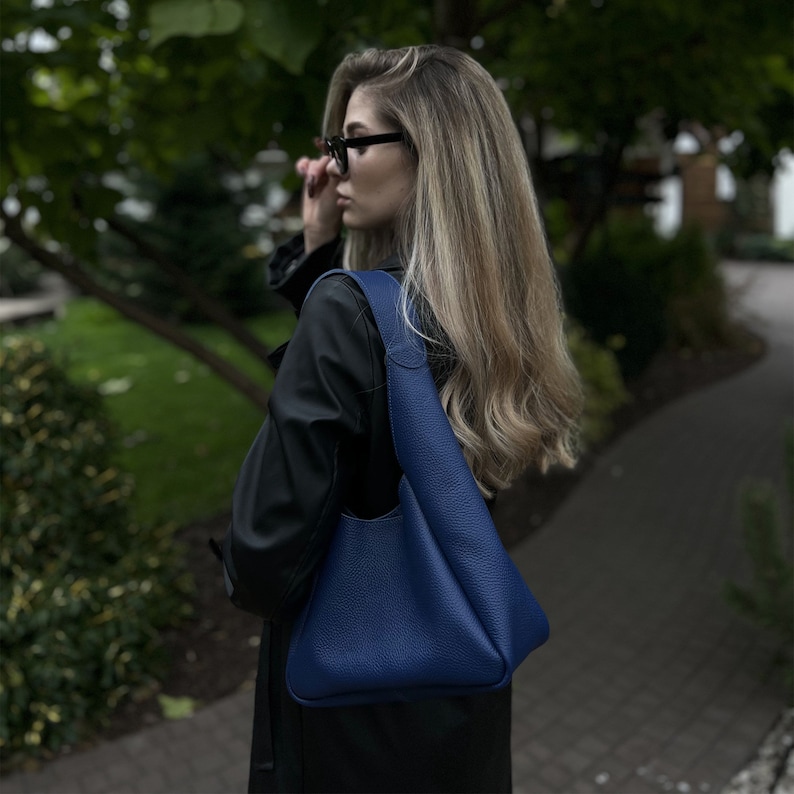 Blue leather hobo bag, spacious soft shoulder purse for women, made from high-quality genuine leather, minimalist modern design with comfortable handle, comes with matching leather wallet.