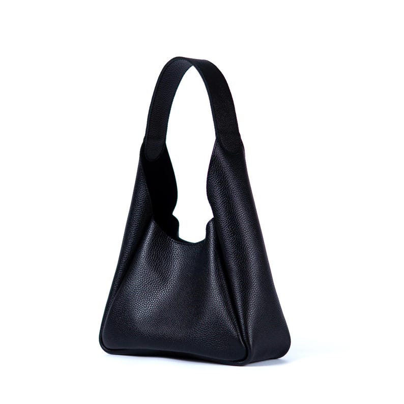 Black leather hobo bag with wide strap on white background