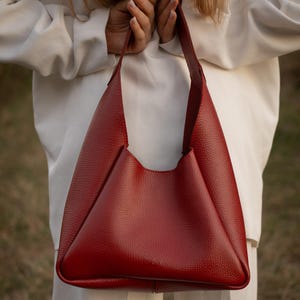 Red leather hobo bag with wallet, handmade genuine leather shoulder bag for women, stylish and functional, everyday handbag with magnetic button closure and durable textured leather.
