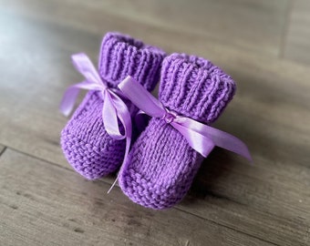 Knitted baby booties with ribbon