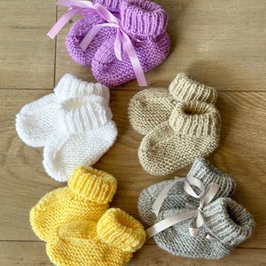 Knitted baby booties with ribbon