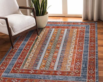 May include: A blue, orange, and red patterned area rug with a geometric design. The rug has a distressed look and is made of a soft, durable material.