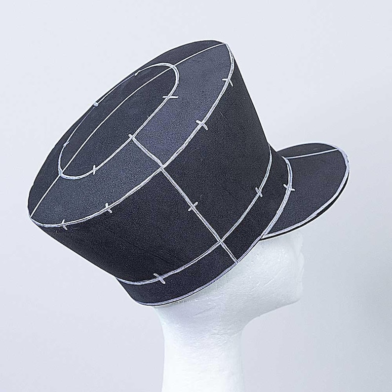 May include: A black hat with a white grid pattern and a brim. The hat is made of a stiff material and has a rounded crown.