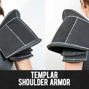 May include: Black Templar shoulder armour with white markings. The armour is made of a dark material and is designed to protect the shoulder and upper arm. The image also includes the text "TEMPLAR SHOULDER ARMOR".