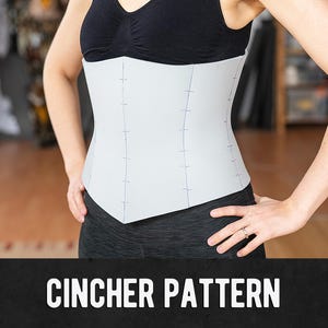 Puede incluir: Se muestra un patrón de cincher gris claro, usado sobre una camiseta sin mangas y leggings negros. El cincher tiene marcas verticales y horizontales. El texto "CINCHER PATTERN" se muestra en letras blancas sobre un fondo negro.