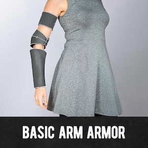 May include: Gray arm armor set, including a forearm guard, elbow guard, and upper arm guard. The armor is made of a dark gray material with white stitching. The text "BASIC ARM ARMOR" is displayed at the bottom of the image.