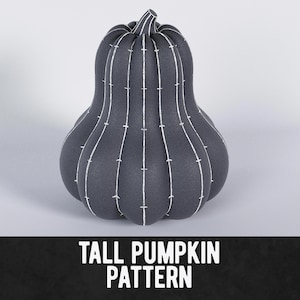 May include: A dark grey pumpkin with white stitching detail. The pumpkin has a ribbed design and a stem at the top. The text "TALL PUMPKIN PATTERN" is at the bottom of the image. This decorative pumpkin is perfect for autumn.