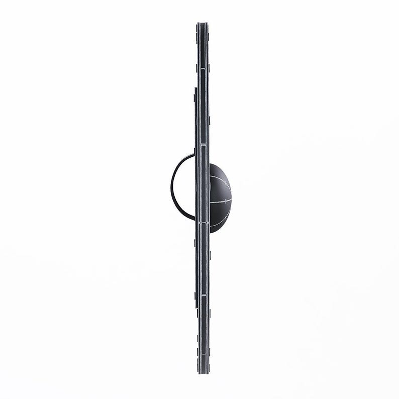 May include: A black and silver medieval shield with a central boss and a handle. The shield has a vertical rectangular shape with a rounded top and bottom. The boss is a rounded, spherical shape with a black handle.