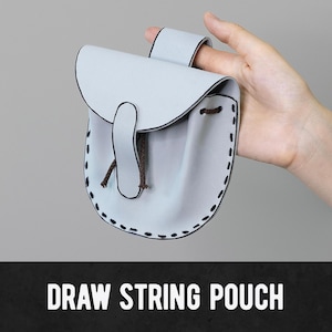 May include: A light blue draw string pouch with a flap closure and a brown drawstring. The pouch has black stitching around the edges. The text "DRAW STRING POUCH" is displayed in white letters at the bottom of the image.