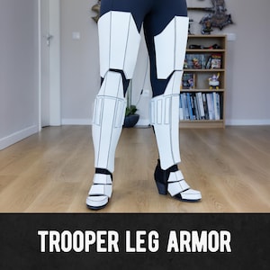 May include: White and black Trooper leg armor. The armor is made of white panels with black outlines and is worn over black leggings. The text "TROOPER LEG ARMOR" is displayed in white on a black banner at the bottom of the image.