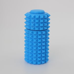 May include: A vibrant blue, cylindrical container with a textured, spiky surface. The container is made of two stacked sections, with a small, flat-topped lid. The design features a repeating pattern of triangular protrusions.