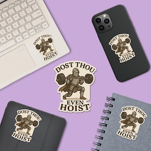 May include: Various stickers and decals displaying a cartoon knight lifting weights. The knight is in armour and a cape, with the text "DOST THOU EVEN HOIST". The stickers are on a laptop, phone, tablet, and notebook.