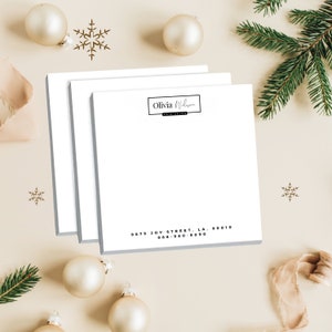 May include: A stack of three white notepad paper with a black border and the text "Olivia Wilson Hair Salon" and the address "9679 Joy Street, LA, 90010 888-980-9090" printed on the bottom.