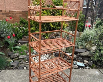 May include: A four-tiered bamboo shelf unit with a woven design. The shelf is made of natural brown bamboo and has a rustic look.