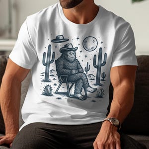 Bigfoot Cowboy T-Shirt, Desert Sasquatch Tee, Western Yeti Design, Moon Stars, UFO T-Shirt, Cryptozoology Gift, Funny Creature Shirt