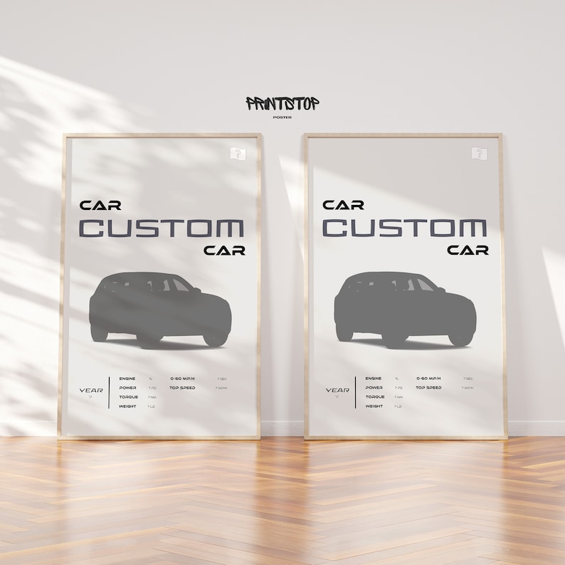 May include: Two framed posters with the text "CAR CUSTOM CAR" in black and white. Each poster features a silhouette of a car in gray against a white background. The posters have a white border and are displayed on a wooden floor.
