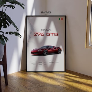 May include: Framed poster featuring a red Ferrari 296 GTB sports car. The poster includes the car's name, year, and performance specifications. The background is a light gray with a mountain illustration.