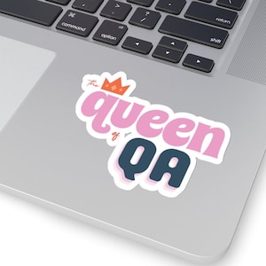 May include: A pink and white sticker with the text "the queen of QA" in a retro font. A small orange crown is above the word "queen".