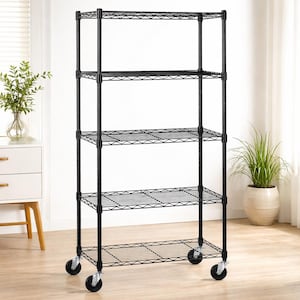 May include: A black metal shelving unit with five wire shelves. The unit has a rectangular shape and is mounted on four caster wheels. The shelves are evenly spaced and the unit is empty. The background includes a white wall and a wooden floor.