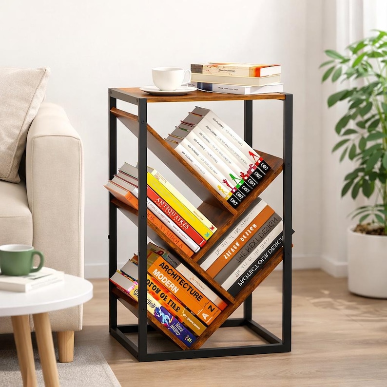 Puede incluir: Una estanter&iacute;a moderna con una tapa de madera marr&oacute;n oscuro y estantes en &aacute;ngulo. Los estantes est&aacute;n llenos de libros de varios tama&ntilde;os y colores. El marco es de metal negro. Una taza de t&eacute; y un platillo blancos est&aacute;n encima.