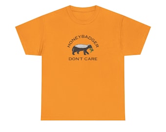 May include: A yellow t-shirt with a black and white illustration of a honey badger with the text "Honey Badger Don't Care" in a black circle.