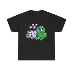 May include: Black t-shirt featuring a cartoon illustration of a green character with two eyes and a purple crown-shaped object. The design includes bubbles and is printed on a black, short-sleeved tee.