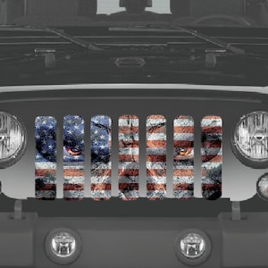 May include: A black Jeep Wrangler with a custom grille featuring an American flag design with an eagle's eye in the center.