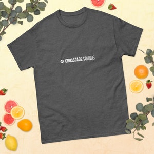 May include: A dark heather grey t-shirt with the text "CROSSFADE SOUNDS" in white on the front.