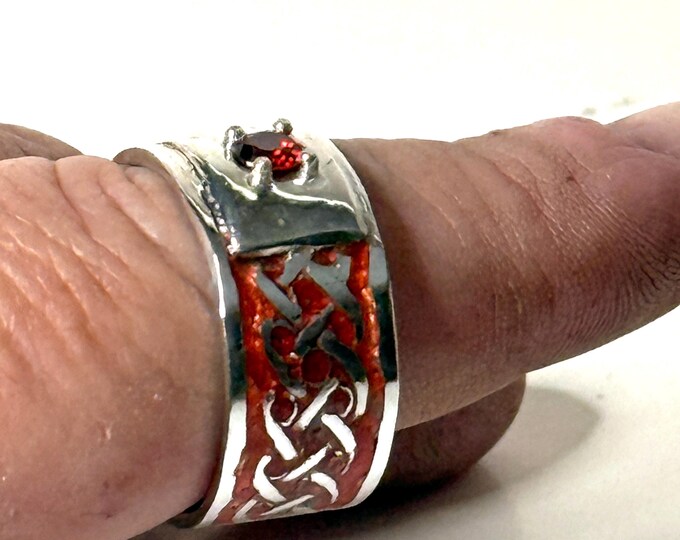 Sterling Silver Celtic Knot design with red enamel inlay with a single garnet