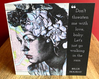 May include: A black and white illustration of a woman with flowers in her hair. The quote "Don't threaten me with love, baby. Let's just go walking in the rain" is printed below the illustration. The artist's name, Billie Holiday, is printed below the quote.
