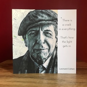 May include: A black and white illustration of Leonard Cohen, a Canadian singer-songwriter, poet, and novelist. The quote "There is a crack in everything. That's how the light gets in." is printed below the illustration.