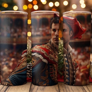 May include: Three stainless steel tumblers with a colorful image of a man in a red and gold costume. The man is standing in a crowd of people. The tumblers are a great way to enjoy your favorite beverage.
