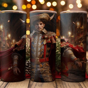 May include: Three stainless steel tumblers with a red, gold, and black design featuring a man in a red and gold costume. The man is holding a sword and has a red cape.