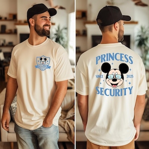 May include: Cream-colored t-shirt featuring a Mickey Mouse graphic. The front displays a shield with Mickey's face and the text "Princess Security". The back has a larger Mickey graphic with the words "Princess Security" and "Since 2025".
