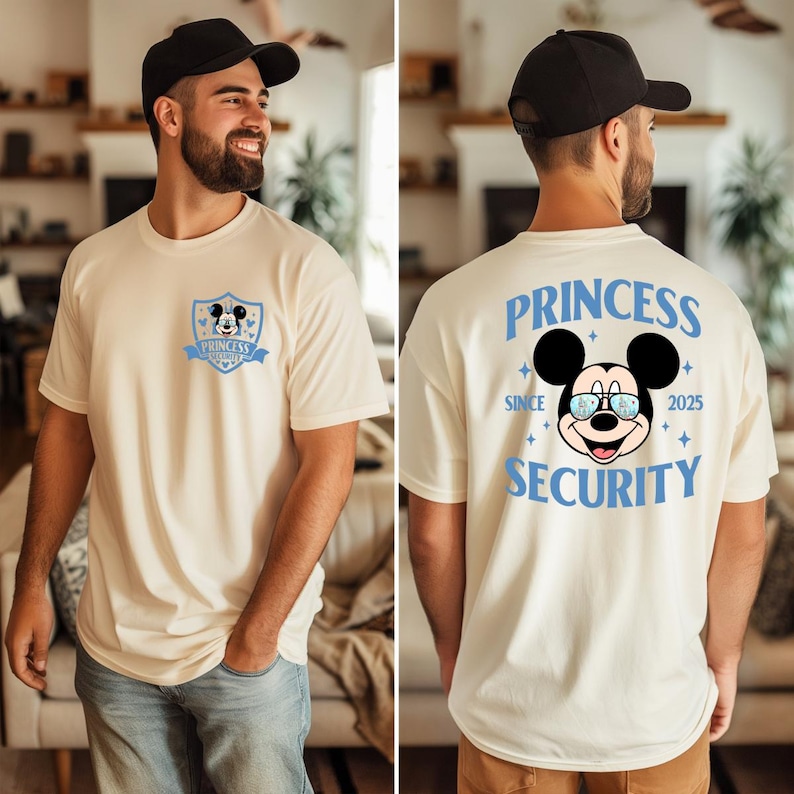 May include: Cream-colored t-shirt featuring a Mickey Mouse graphic. The front displays a shield with Mickey's face and the text "Princess Security". The back has a larger Mickey graphic with the words "Princess Security" and "Since 2025".