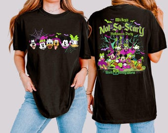 May include: A black t-shirt featuring a front graphic of Disney characters in Halloween costumes and a back graphic with the text Mickey's Not-So-Scary Halloween Party Walt Disney World, depicting a haunted castle, bats, and spiderwebs.