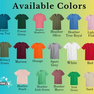 May include: A selection of t-shirts in a variety of colours, such as teal, green, pink, olive, and blue. The text "Available Colors" is at the top. The shirts are arranged in rows, displaying a spectrum of shades from light to dark.