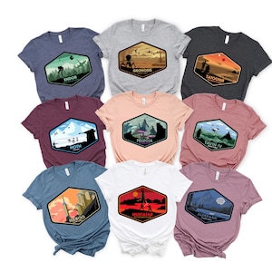 May include: Nine different t-shirts featuring Star Wars planets. Each shirt has a different planet design with the planet's name and a short description. The planets featured are Endor, Geonosis, Tatooine, Hoth, Felucia, Yavin IV, Naboo, Mustafar, and Alderaan.
