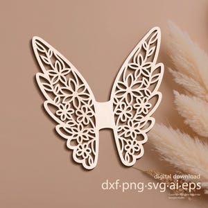May include: A wooden cutout of angel wings with a floral design. The wings are light brown and feature intricate cut-out details of flowers and leaves. The words "digital download" and file type extensions are visible.