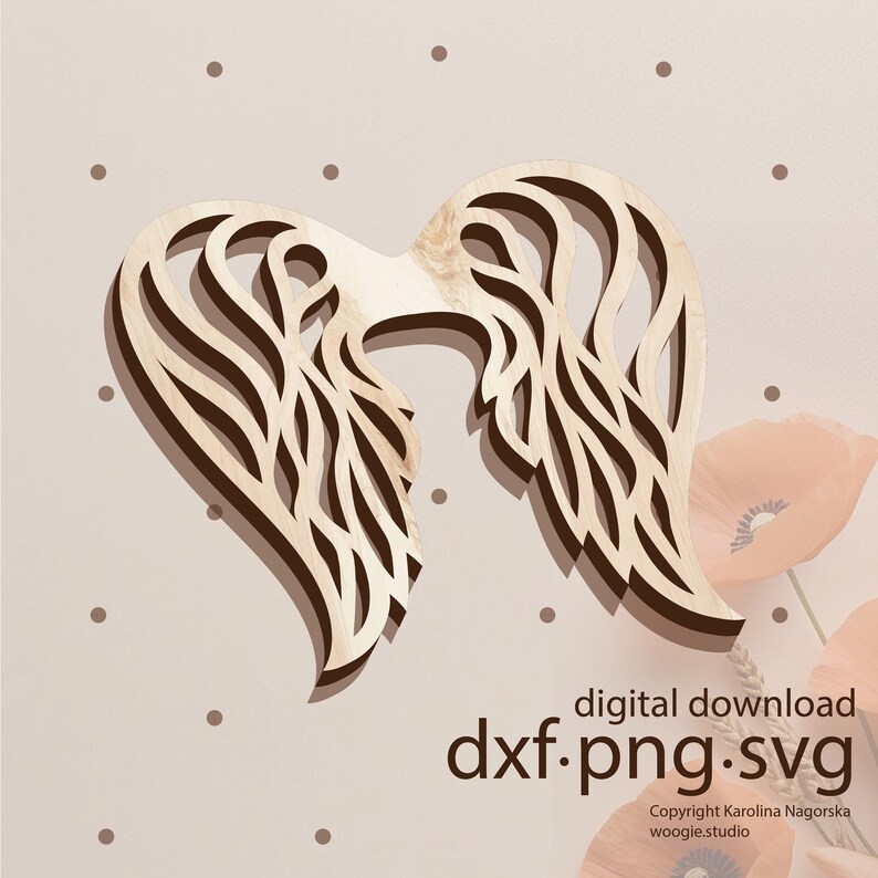 May include: A wooden cutout of a pair of angel wings with a detailed, intricate design. The wings are light brown and have a heart shape.