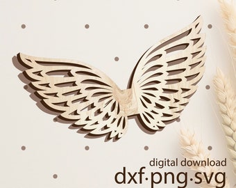 Puede incluir: Corte de madera de un par de alas de ángel con un diseño detallado e intrincado. Las alas son de color marrón claro y tienen un efecto 3D. La imagen incluye el texto "descarga digital dxf.png.svg Copyright Karolina Nagorska woogie.studio".